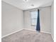 Bedroom with neutral carpet, and window with a dark blue curtain at 10574 Siesta Key St, Las Vegas, NV 89141