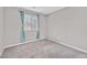Cozy bedroom filled with natural light showcasing gray walls and neutral carpet at 10574 Siesta Key St, Las Vegas, NV 89141