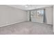 Bedroom with neutral carpet, window, and grey curtains at 10574 Siesta Key St, Las Vegas, NV 89141
