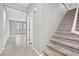 Entry hallway featuring tile floor, leading to a carpeted staircase at 10574 Siesta Key St, Las Vegas, NV 89141