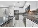 Modern kitchen featuring granite countertops, stainless steel appliances, and white cabinets at 10574 Siesta Key St, Las Vegas, NV 89141