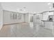 Bright living room featuring neutral walls, tiled floors, and a pass through to the kitchen at 10574 Siesta Key St, Las Vegas, NV 89141