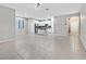 Bright living room featuring neutral walls, tiled floors, and an open layout leading to the kitchen at 10574 Siesta Key St, Las Vegas, NV 89141