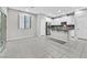 Bright living room featuring neutral walls, tiled floors, a pass through to the kitchen, and glass patio doors at 10574 Siesta Key St, Las Vegas, NV 89141