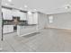Living room featuring neutral walls, tiled floors, an open layout, and an island with granite counters at 10574 Siesta Key St, Las Vegas, NV 89141