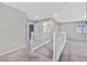 Upstairs loft area with neutral carpeting and white banister at 10574 Siesta Key St, Las Vegas, NV 89141