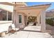 Relaxing covered patio with ceiling fan, seating, and access to the backyard at 10971 Civiletti St, Las Vegas, NV 89141