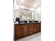 Bathroom featuring dual sinks, a walk-in shower, and a large mirror at 125 E Harmon Ave # 3406 & 3408, Las Vegas, NV 89109