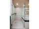 Bright bathroom featuring a glass enclosed shower and soaking tub with neutral tiling and art at 125 E Harmon Ave # 3406 & 3408, Las Vegas, NV 89109