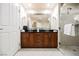Bathroom featuring dual sinks, a walk-in shower, and a large mirror at 125 E Harmon Ave # 3406 & 3408, Las Vegas, NV 89109