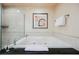 Bright bathroom featuring a glass enclosed shower and soaking tub with neutral tiling and art at 125 E Harmon Ave # 3406 & 3408, Las Vegas, NV 89109