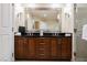 Bathroom featuring dual sinks, a walk-in shower, and a large mirror at 125 E Harmon Ave # 3406 & 3408, Las Vegas, NV 89109