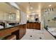 Luxurious bathroom with dual vanities, a soaking tub, a separate shower, and tile flooring at 125 E Harmon Ave # 3406 & 3408, Las Vegas, NV 89109