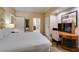 Cozy bedroom featuring a king-size bed, workspace, and access to the ensuite bathroom at 125 E Harmon Ave # 3406 & 3408, Las Vegas, NV 89109
