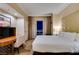 Comfortable bedroom with a large bed, desk, and balcony access with city views at night at 125 E Harmon Ave # 3406 & 3408, Las Vegas, NV 89109