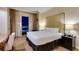 Bright bedroom featuring a king-size bed, city views, and a stylish nightstand with lamps at 125 E Harmon Ave # 3406 & 3408, Las Vegas, NV 89109