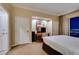 Cozy bedroom with neutral decor, a work space, and a view of the city lights at night through the curtains at 125 E Harmon Ave # 3406 & 3408, Las Vegas, NV 89109