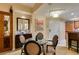 Stylish dining area with glass table, seating for four, and kitchen access at 125 E Harmon Ave # 3406 & 3408, Las Vegas, NV 89109