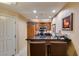 Modern kitchen area features wood cabinetry, stainless steel appliances, and a sleek black countertop with bar seating at 125 E Harmon Ave # 3406 & 3408, Las Vegas, NV 89109