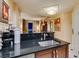 Modern kitchen with black countertops, stainless steel appliances, and wooden cabinetry, creating an inviting cooking space at 125 E Harmon Ave # 3406 & 3408, Las Vegas, NV 89109
