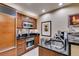 Modern kitchen with wood cabinets, stainless steel appliances, and black granite countertops for a stylish and functional cooking space at 125 E Harmon Ave # 3406 & 3408, Las Vegas, NV 89109