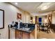 Modern kitchen with a bar area that looks into the dining area with seating and views of the bright city at 125 E Harmon Ave # 3406 & 3408, Las Vegas, NV 89109