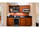 Kitchenette features dark wood cabinets, a sink, a microwave, and a beverage cooler at 125 E Harmon Ave # 3406 & 3408, Las Vegas, NV 89109