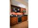 Kitchenette featuring dark wood cabinets, a sink, a microwave, and a beverage cooler at 125 E Harmon Ave # 3406 & 3408, Las Vegas, NV 89109
