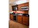 Kitchenette featuring dark wood cabinets, a sink, a microwave, and a beverage cooler at 125 E Harmon Ave # 3406 & 3408, Las Vegas, NV 89109