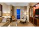 This living room offers cozy seating, bright lighting, and stunning panoramic city views at 125 E Harmon Ave # 3406 & 3408, Las Vegas, NV 89109