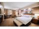 Spacious main bedroom featuring a king bed, sitting area, and city views at 125 E Harmon Ave # 3406 & 3408, Las Vegas, NV 89109