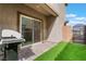An inviting outdoor space featuring a built-in grill, artificial grass, and sliding door entrance into the house at 1364 Cerulean Ave, Henderson, NV 89002