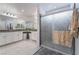 Bright bathroom with a white double sink vanity, granite counters, and large glass-enclosed shower at 1364 Cerulean Ave, Henderson, NV 89002
