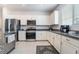 Bright kitchen features stainless steel appliances and ample white cabinetry at 1364 Cerulean Ave, Henderson, NV 89002