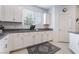 Kitchen features stylish grey veined granite countertops and white cabinets at 1364 Cerulean Ave, Henderson, NV 89002