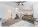 Open-concept living room with staircase, comfortable seating, and seamless flow to the kitchen and dining area at 1364 Cerulean Ave, Henderson, NV 89002