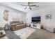 Cozy living room features plush carpeting, ceiling fan, and a stylish entertainment center with decor at 1364 Cerulean Ave, Henderson, NV 89002