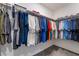 Generous walk-in closet is filled with colorful shirts and clothes at 1364 Cerulean Ave, Henderson, NV 89002
