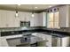 Updated kitchen features white cabinets, granite counters, and stainless steel appliances at 176 Brighton Hills Ave, Henderson, NV 89002