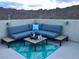 Stylish outdoor patio with comfortable seating, a coffee table, and mountain views for relaxing and entertaining at 176 Brighton Hills Ave, Henderson, NV 89002