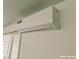 Image shows a close up of an AC Unit installed on a wall, located above blinds at 1828 Casa Vista Dr, Las Vegas, NV 89146