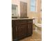 A charming bathroom is adorned with a granite countertop and elegant wooden cabinets, offering timeless style at 1828 Casa Vista Dr, Las Vegas, NV 89146