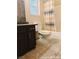 A compact bathroom is adorned with neutral-toned tiling and a matching shower curtain adding a touch of flair at 1828 Casa Vista Dr, Las Vegas, NV 89146