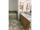 Bathroom featuring a soaking tub, granite countertop, and wood cabinetry at 1828 Casa Vista Dr, Las Vegas, NV 89146