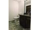 Bathroom featuring tile flooring, granite countertops, and wood cabinetry at 1828 Casa Vista Dr, Las Vegas, NV 89146