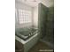 Bright bathroom with tub featuring attractive tile work and a shower at 1828 Casa Vista Dr, Las Vegas, NV 89146