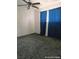 A simple bedroom with neutral carpet is brightened by blue curtains filtering soft, natural light at 1828 Casa Vista Dr, Las Vegas, NV 89146