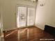 This bright bedroom features hardwood floors and access to the outdoors through glass doors at 1828 Casa Vista Dr, Las Vegas, NV 89146