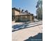 Exterior side view of a two-story home featuring an extended driveway and brick accents at 1828 Casa Vista Dr, Las Vegas, NV 89146