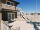This inviting exterior features a staircase leading to an upper deck and a unique stone-accented backyard at 1828 Casa Vista Dr, Las Vegas, NV 89146